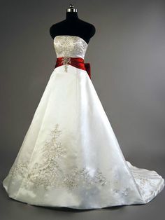 a white and red wedding dress on display