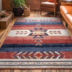 a living room area with a couch, chair and rug