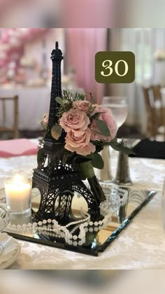 the eiffel tower is decorated with flowers and pearls for an elegant centerpiece