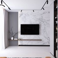 a living room with white marble walls and flooring, along with a tv mounted on the wall