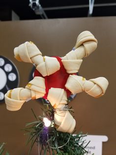 an ornament made to look like a teddy bear is hanging from a christmas tree