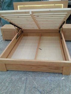 a wooden bed frame with two drawers open