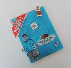 This is a wonderful vintage mens Fruit of the Loom t-shirt from 1987. It is a turquoise color with a pocket on the chest and is 100% preshrunk cotton. It is still in the original sealed packaging and was made in the USA. T Shirt Packaging, Clothing Labels Design, Shirt Packaging, Tshirt Packaging, Labels Design, Hand Painted Pottery, Vintage Fruit, Color Kit, Black Pumps Heels