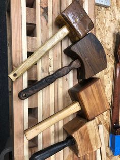 several different types of woodworking tools on wooden planks with hammers and chisel