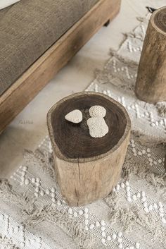 two wooden pieces with white hearts on them sitting on a lace doily next to a bed