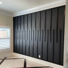 an empty room with black and white striped flooring