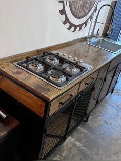 a stove top oven sitting inside of a kitchen next to a counter with two burners