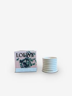 an empty bowl sitting next to a box of loewe