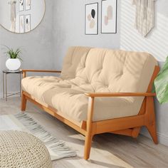 a living room scene with focus on the futon and rug in the foreground