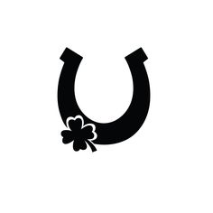 a black and white image of a horseshoe with clovers on it's side