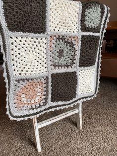 a crocheted blanket sitting on top of a chair