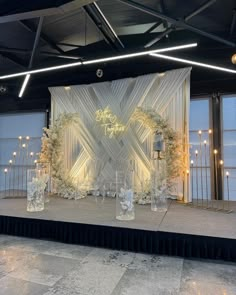 a stage set up with flowers and candles