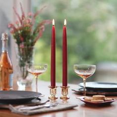 the table is set with wine, crackers and two candles