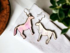 These are birch wood  hand painted, .925 sterling silver Around 2 inch long Whimsical Hand Painted Silver Earrings, Charlie The Unicorn, Unicorn Earrings, The Unicorn, Birch Wood, Dumb And Dumber, Favorite Jewelry, Jewelry Earrings Dangle, Etsy Earrings