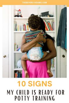 a woman holding a baby in her arms with the words 10 signs my child is ready for potty training