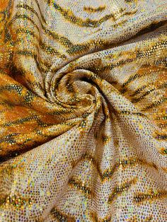 an orange and gold colored fabric with small dots on the top, as if it was made out of cloth