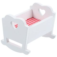 a white wooden toy crib with a red checkered tablecloth on the bottom