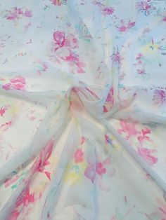 the fabric is white with pink and yellow flowers on it