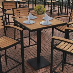 tables and chairs with napkins on them are set up for an outdoor dining event