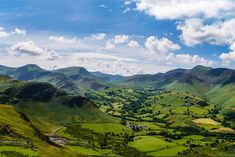 green hills and valleys with clouds in the sky