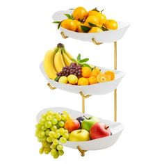 three tiered trays filled with different types of fruit