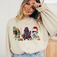 a woman wearing a star wars christmas sweatshirt