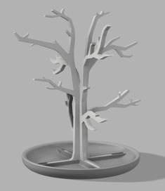 a paper sculpture of a tree on a plate