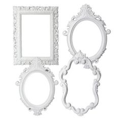 three white frames with ornate designs on the sides and one has a small mirror above it