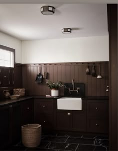 a black and white kitchen with wooden cabinets