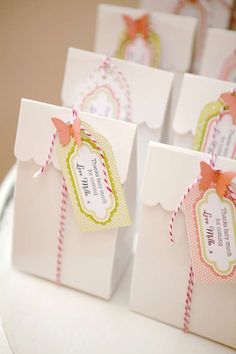 small white bags with tags on them sitting on a table