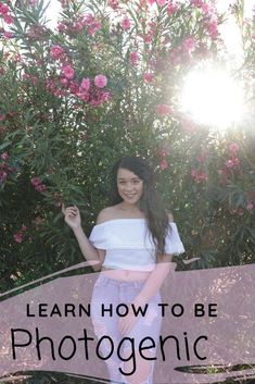 a woman standing in front of flowers with the words learn how to be photogenic