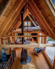 an aerial view of a living room and kitchen area in a small cabin style home