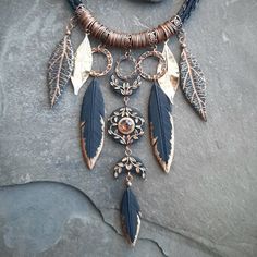 This festive and statement necklace I made of polymer clay and hammered copper has a triple Moon as a centerpiece - a powerful Pagan / Wiccan feminine symbol that represents stages in the female life cycle and Moon phases. The necklace is decorated with smoky quartz (rauhtopaz), vine ornaments and feathers and leaves shaped elements that represent Nature. Necklace length is about 20 inches (can be made in another length if needed - please inquire) Central element length is about 5 inches Will pe Black Copper Bohemian Jewelry, Black Bohemian Copper Jewelry, Bohemian Polymer Clay Jewelry For Festivals, Bohemian Black Copper Necklace, Bohemian Black Jewelry Made Of Polymer Clay, Black Copper Bohemian Necklaces, Black Bohemian Copper Necklace, Bohemian Gold Polymer Clay Jewelry, Gold Bohemian Polymer Clay Jewelry