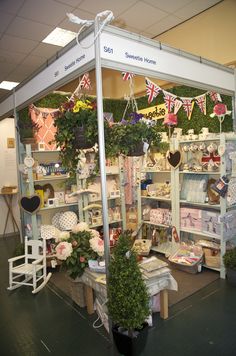 a display case filled with lots of toys and plants in front of a flag banner