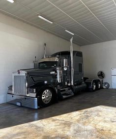 a large semi truck parked in a garage