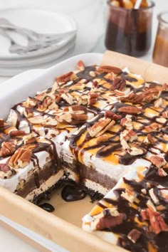 a dessert with chocolate, pecans and nuts on top