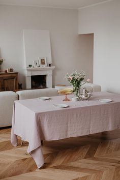 a dining room table with plates and flowers on it