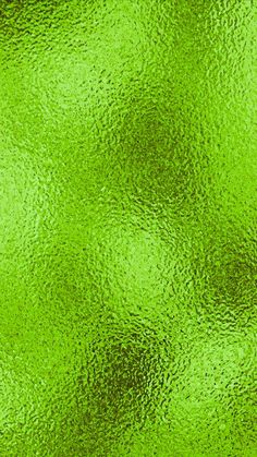 an abstract green background that looks like it has been painted with metallic foil and is very shiny