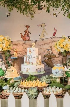 a winnie the pooh birthday party with cake and cupcakes