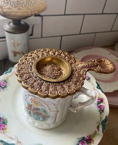 there is a tea cup and saucer on the plate