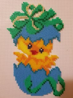 a cross stitch picture of a pikachu holding a plant on top of it