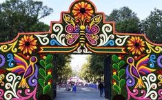 an elaborately decorated gate in the middle of a park