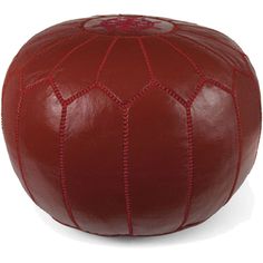 a red leather poufce sitting on top of a white floor