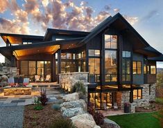 a large house sitting on top of a lush green hillside