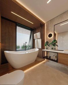 a bathroom with a large white bathtub next to a window