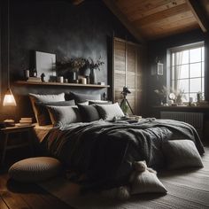 a bedroom with black walls and wooden floors, large bed surrounded by pillows and blankets