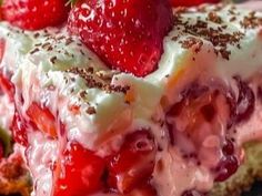 a close up of a dessert with strawberries and cream on the top of it