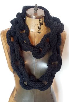 a mannequin wearing a black knitted scarf