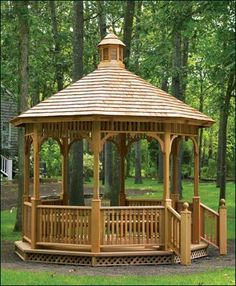 a wooden gazebo sitting in the middle of a park