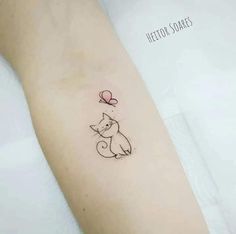 a small cat with a balloon tattoo on the left inner arm, and an arrow in the middle